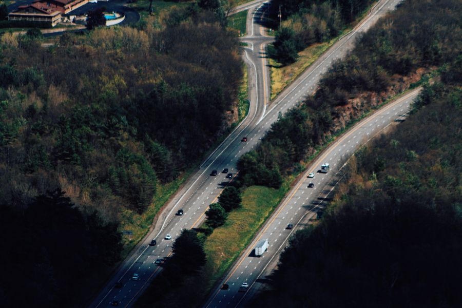 A road cutting through snow-covered forest